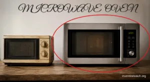This image shows a microwave oven placed on a wooden surface, illustrating its invention by accident.